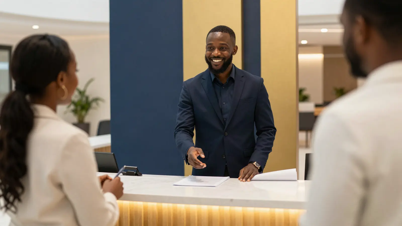 AI-generated illustration: a smiling host at a welcome desk answering a guest's question in a bright foyer